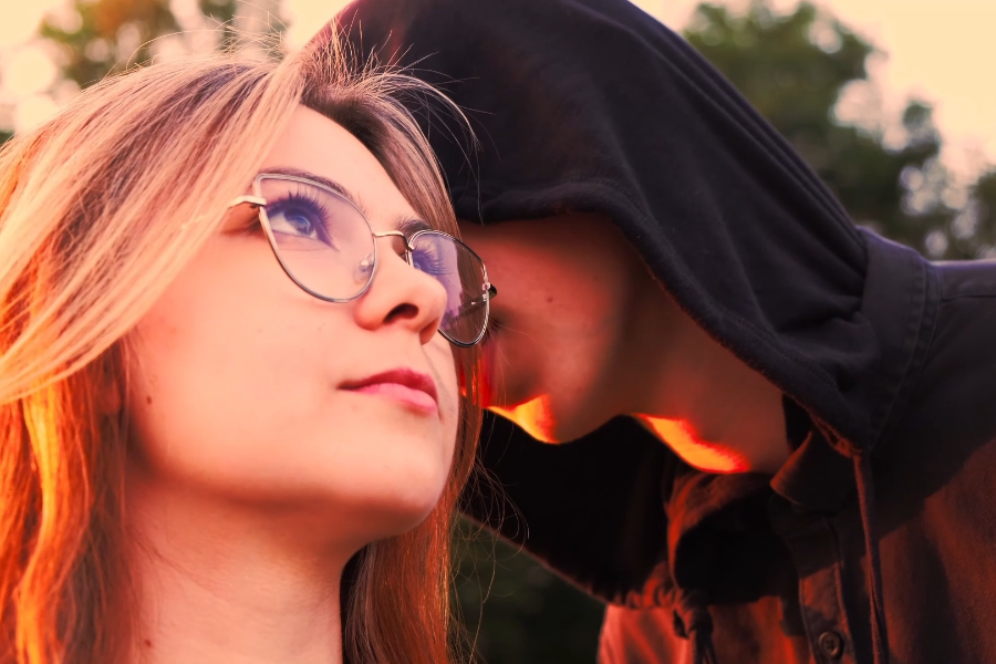 Kadr z filmu "Cień". Dziewczyna patrzy w niebo. Chłopak szepcze jej coś na ucho.